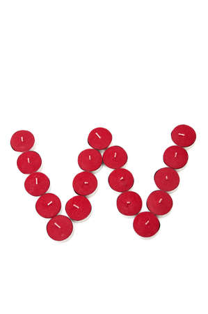 Letter W formed by candles on a white backgroundの写真素材