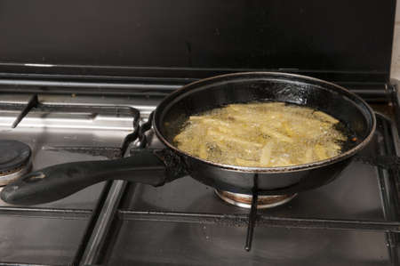 cooking pan fries on the kitchenの写真素材