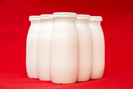 milk cans on a red backgroundの写真素材