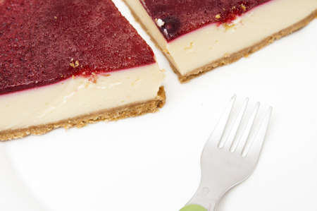 cheesecake with strawberry syrup on a white background