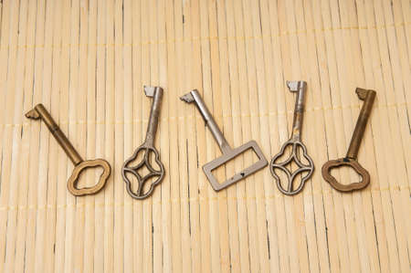 old keys on a wooden backgroundの写真素材