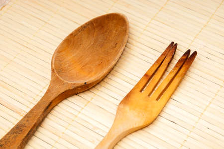 Wooden kitchen utensils on a wooden backgroundの写真素材