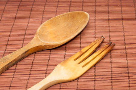Wooden kitchen utensils on a wooden backgroundの写真素材