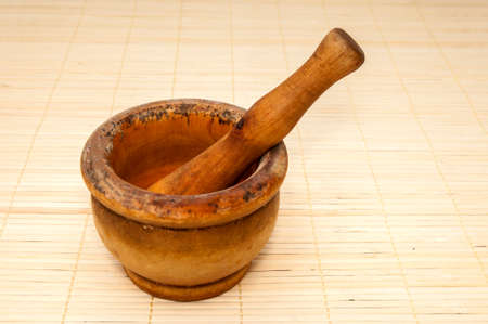 mortar to nibble on a wooden  backgroundの写真素材