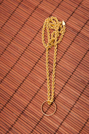 necklace with ring on a wooden backgroundの写真素材