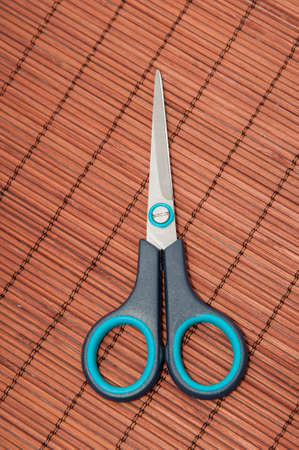 scissors to cut on a wooden backgroundの写真素材