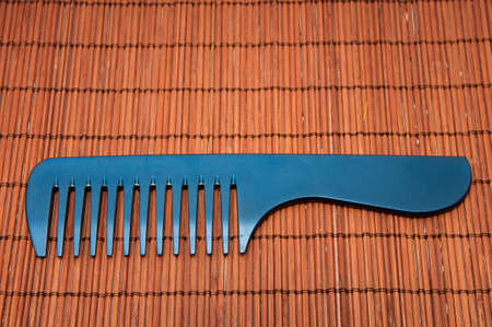 comb black on a wooden backgroundの写真素材