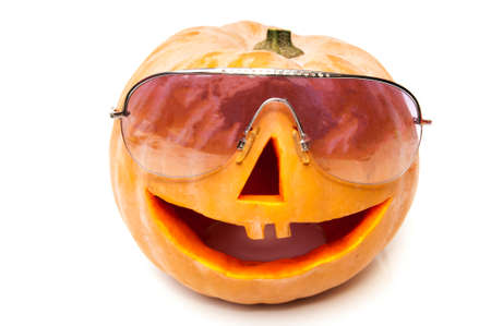 halloween pumpkin with glasses on a white backgroundの写真素材