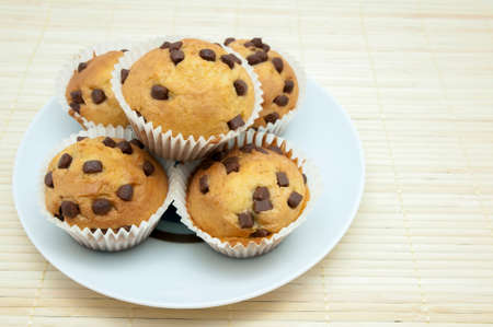 chocolate muffins on a wooden backgroundの写真素材