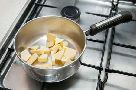 butter in a cooking pot on the fireの写真素材