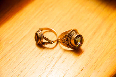 gold rings with gems on a wooden backgroundの写真素材