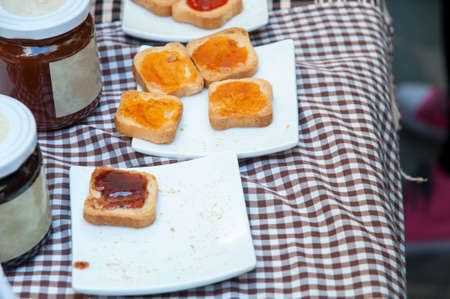 toast with jam on a checkered tablecloth