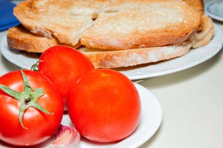 tomatoes with garlic and bread on a plate ready to eatの写真素材