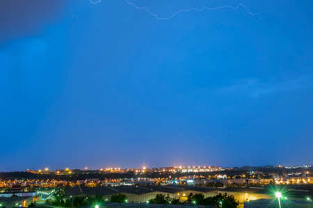 thunderstorm at night with city lights backgroundの写真素材