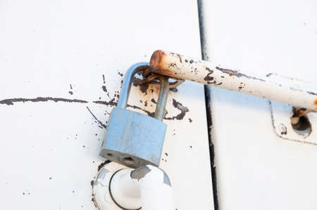 silver padlock attaching a doorの写真素材