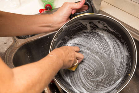 washing dishes with soap and waterの写真素材