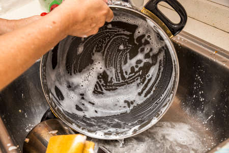 washing dishes with soap and waterの写真素材