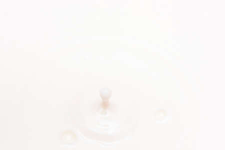 drop of milk falling and splashingの写真素材