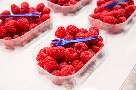 colored red raspberries ready to eatの写真素材