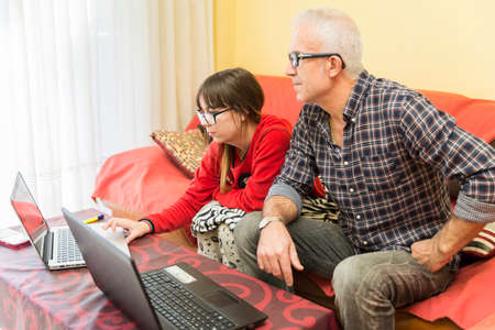 Young man and woman working together at home
