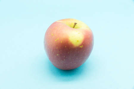 ripe apple on a blue backgroundの写真素材