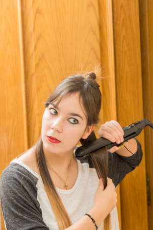 Woman combing her hair with a machine