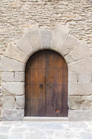 old wooden door with stone wallの写真素材