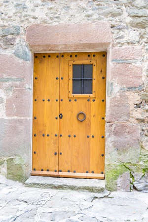 old wooden door with stone wallの写真素材