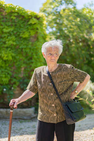 portrait of an old woman surrounded by natureの写真素材