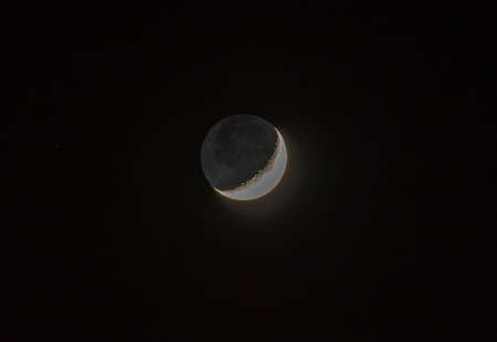 crescent moon in the sky surrounded by starsの写真素材