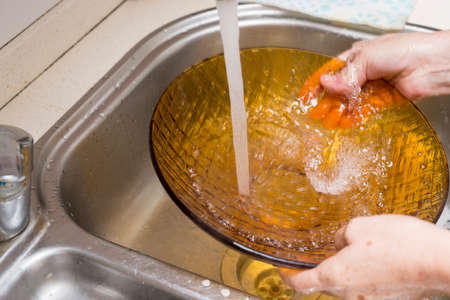 washing dishes with soap and waterの写真素材