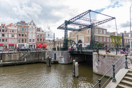 Canals of Amsterdam capital city of the Netherlands with its local boats and bridgesのeditorial素材