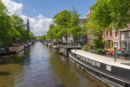 Canals of Amsterdam capital city of the Netherlands with its local boats and bridgesのeditorial素材