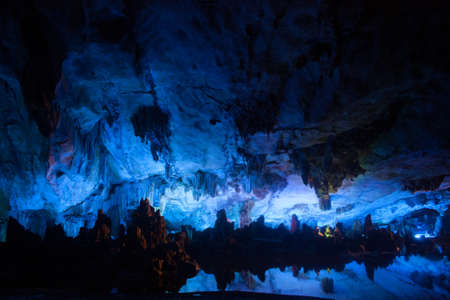 Vast cave with multicolored lighting & guided tours featuring diverse stalagmites & stalactitesの写真素材