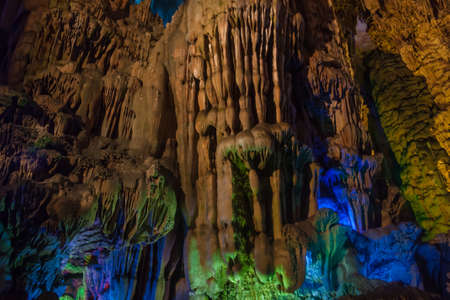 Vast cave with multicolored lighting & guided tours featuring diverse stalagmites & stalactitesの写真素材