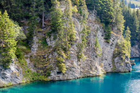 Cliff and blue turquoise water on Saint Gerin lake, Alps, France