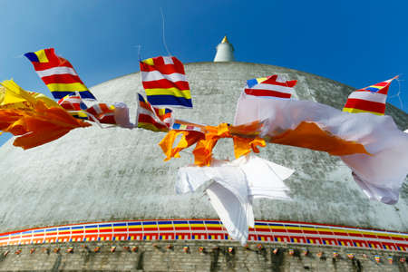 buddhist flag on ruwanwelisaya stupa, in anuradhapura historical park, sri lankaの写真素材