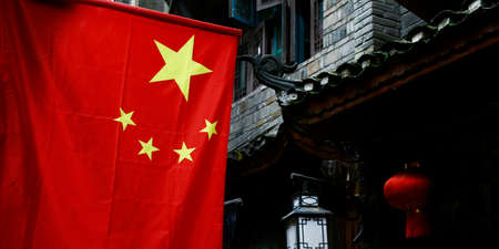 Chinese flag in old city streetのeditorial素材