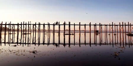 people walking on a bath bridge at Mandalay, Myanmar