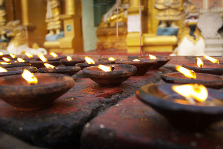 Holy candle in buddhist temple in myanmar