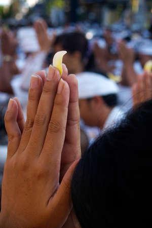 Close up of hand Balinese woman holding flower with traditional costume, during ceremony in Bali-Indonesiaの写真素材