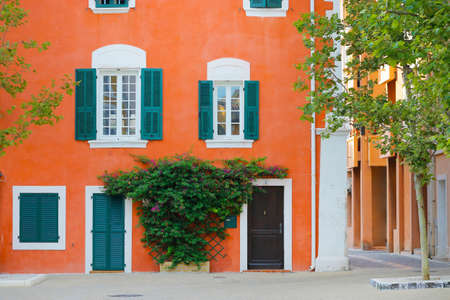 facade of mediterranean building with colorful shutterの写真素材