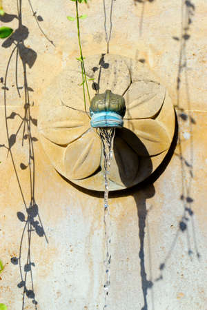 stone fountain in mediterranean villageの写真素材