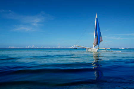 silhouette of boat on the beach in philippinesの写真素材