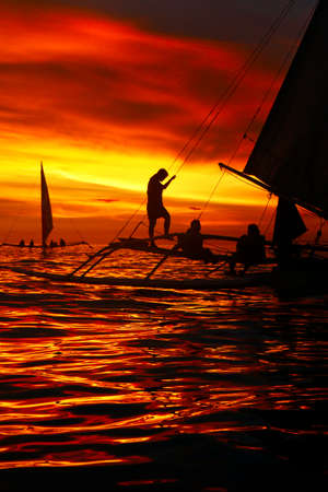 silhouette of boat on the beach during sunset in philippinesの写真素材