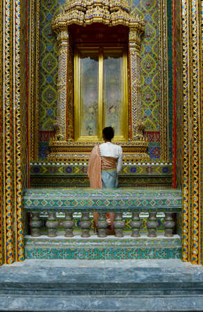 woman with traditional clothes in the buddhist temple rachabopit in the city of bangkok -thailandの写真素材