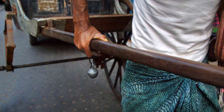 hand of rickshaw puller with bell, in the street of Kolkata -India