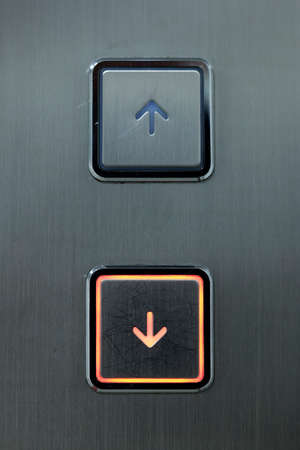 metallic elevator button with arrow design