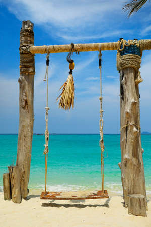 swing on white sand beach in the andaman sea in thailandの写真素材