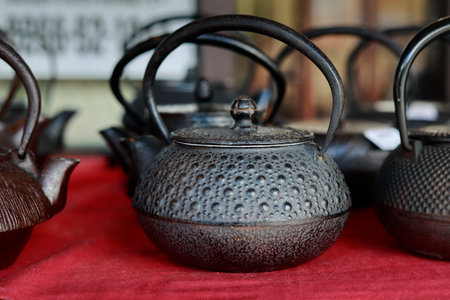 Traditional Japanese teapot on a red tablecloth.の写真素材